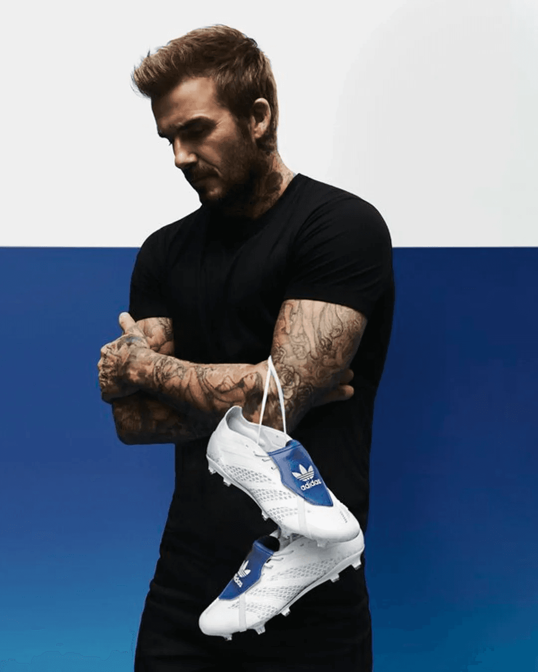 David Beckham for adidas, holding football boots